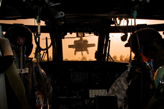 CAMP TAJI, Iraq-During an early morning start, an orange glow from the sun fills the sky as a team of UH-60 Black Hawk helicopters from Company B, 3rd Battalion, 227th Aviation Regiment, 1st Air Cavalry Brigade, 1st Cavalry Division,...