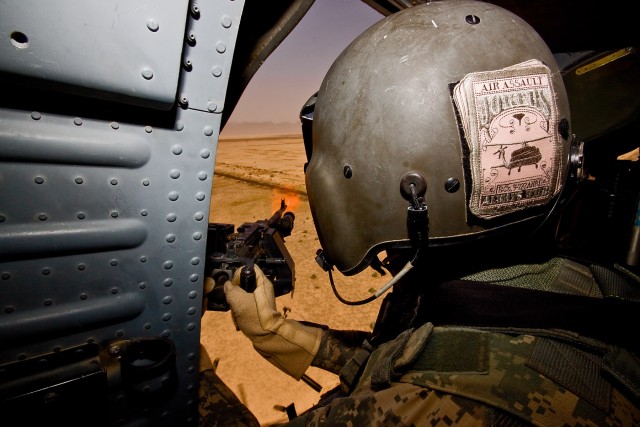 CAMP TAJI, Iraq-A burst of flames leaves the muzzle of a 240B machine gun as Spc. Brandon Perryman, a UH-60 Black Hawk helicopter crew chief in Company B, 3rd Battalion, 227th Aviation Regiment, 1st Air Cavalry Brigade, 1st Cavalry Division,...