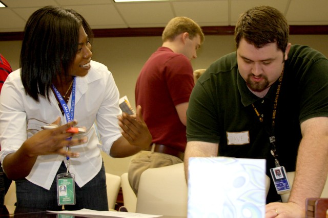 Antoinette Evans and David Kohlhoff, USASMDC/ARSTRAT, work together on a peer project