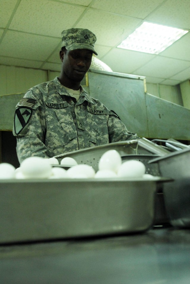 JSS WAREAGLE, Iraq - Newport, R.I. native Pfc. Andre Barrett, cook assigned to 1st "Black Knights" Battalion, 5th Cavalry Regiment, attached to the 1st "Ironhorse" Brigade Combat Team, 1st Cavalry Division, prepares to take boiled eggs out to the...