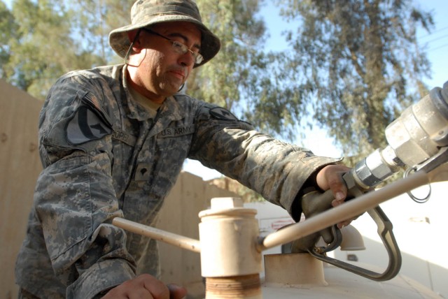 BAGHDAD - San Antonio native, Spc. Andres Lopez, a fueler assigned to Company A, 115th Brigade Support Battalion, 1st Brigade Combat Team, 1st Cavalry Division, replenishes the generator for the "Ironhorse" Brigade's tactical operations center...