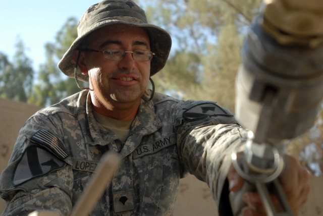 BAGHDAD - San Antonio native, Spc. Andres Lopez, a fueler assigned to Company A, 115th Brigade Support Battalion, 1st Brigade Combat Team, 1st Cavalry Division, replenishes the generator for the "Ironhorse" Brigade's tactical operations center...