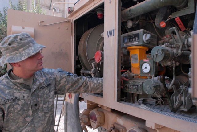 BAGHDAD - Dallas native, Spc. Jeffrey Stubbs, a fueler assigned to Company A, 115th Brigade Support Battalion, 1st Brigade Combat Team, 1st Cavalry Division, manages the fuel system of a Heavy Expanded Multiple Mobility Truck (HEMMT) while his...