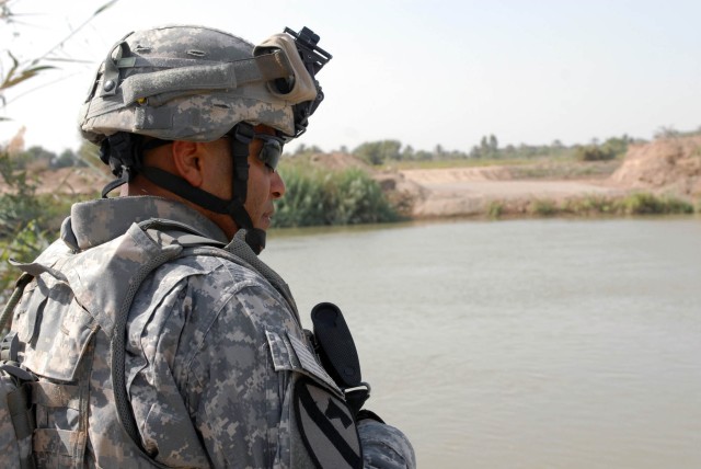 BAGHDAD - Compton, Calif. native, Command Sgt. Maj. James Norman, command sergeant major of the 1st "Ironhorse" Brigade Combat Team, 1st Cavalry Division, checks the progress on the beginning stages of a bridge project between Taji and Istiqlal.  Nor...