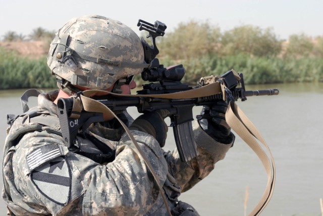 BAGHDAD - Austin, Texas native, Staff Sgt. Brandon Patterson, section sergeant for the personnel security detail for the 1st "Ironhorse" Brigade Combat Team, 1st Cavalry Division, scopes out the surrounding area as they conduct a recon of a bridge Au...