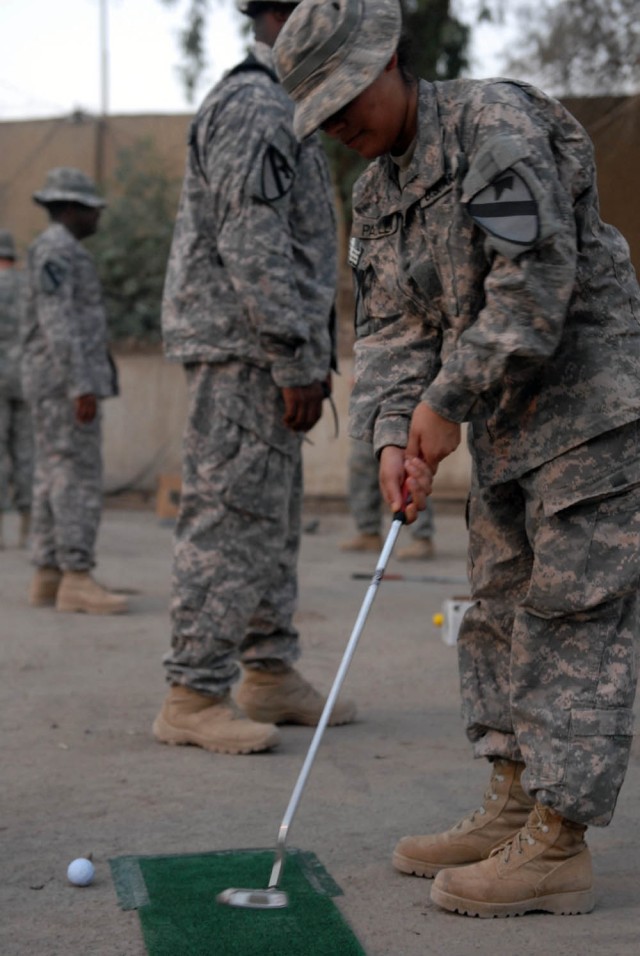 BAGHDAD - Rockingham, N.C. native, Pvt. Anahi Padilla, a human resource specialist assigned to Headquarters and Headquarters Troop, 1st Brigade Combat Team, 1st Cavalry Division, putts during the "Fairways 2 Greens" Golf Tour at Joint Security...