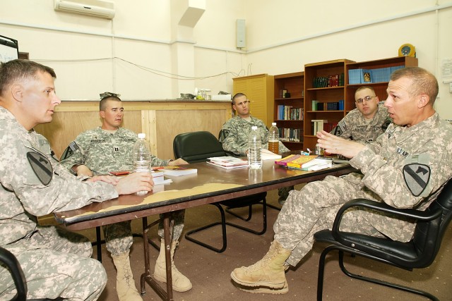 CAMP TAJI, Iraq-Chaplains from the 1st Air Cavalry Brigade, 1st Cavalry Division, Multi-National Division - Baghdad, join together with Chap. (Maj.) Ken Sorenson (far right), of Racine, Wis., the assistant division chaplain for 1st Cav. Div., to disc...