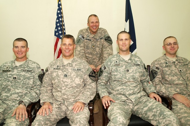 CAMP TAJI, Iraq-Chaplains from the 1st Air Cavalry Brigade, 1st Cavalry Division, Multi-National Division - Baghdad, pause for a picture during a meeting, here, Aug. 19, with Chap. (Maj.) Ken Sorenson (center) of Racine, Wis., the assistant division ...