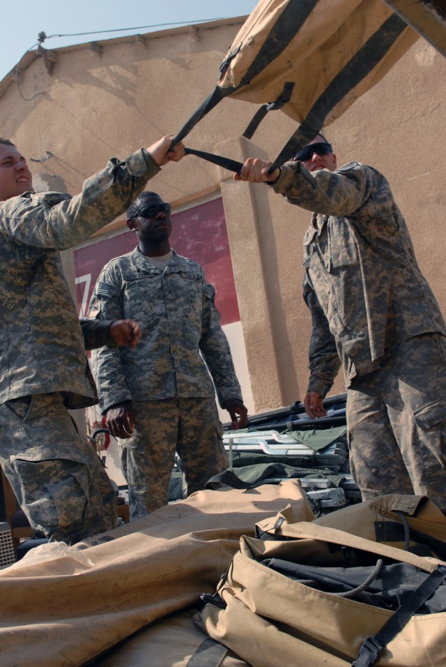 CAMP TAJI, Iraq - Copperas Cove, Texas native Pfc. Kenneth Curtsinger (left) and Killeen, Texas native Pfc. Timothy Dobelbower (right), both artillery cannon crewmembers, assigned to Battery A, 1st Battalion, 82nd Field Artillery, 1st Brigade...
