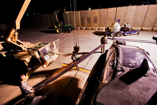 CAMP TAJI, Iraq-While using a Scamp to lower a main rotor blade down from an AH-64D Apache attack helicopter, crew chiefs in Company A, 4th Battalion, 227th Aviation Regiment, 1st Air Cavalry Brigade, 1st Cavalry Division, Multi-National Division...