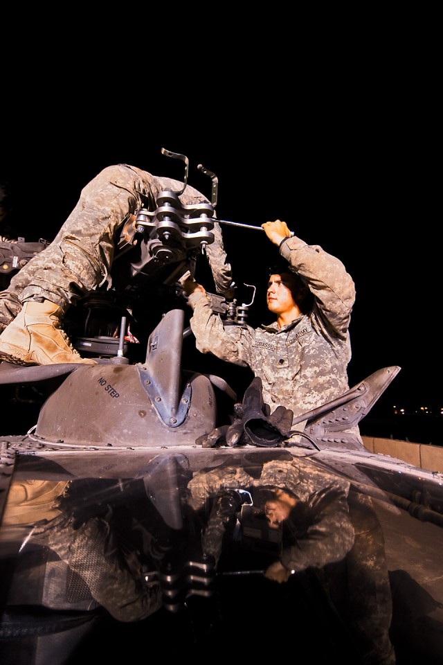 CAMP TAJI, Iraq-Spc. Travis Tobiassen (right), from Fullerton, Calif., an AH-64D Apache attack helicopter crew chief in Company A, 4th Battalion, 227th Aviation Regiment, 1st Air Cavalry Brigade, 1st Cavalry Division, Multi-National Division -...