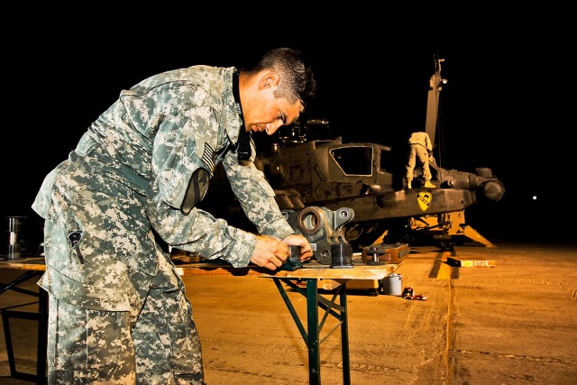 CAMP TAJI, Iraq-After a crew of seven Soldiers removed all four blades and lead lag links from main rotor head of an AH-64D Apache attack helicopter, Spc. Alexander Honey, from Lowville, N.Y., an Apache crew chief in Company A, 4th Battalion,...