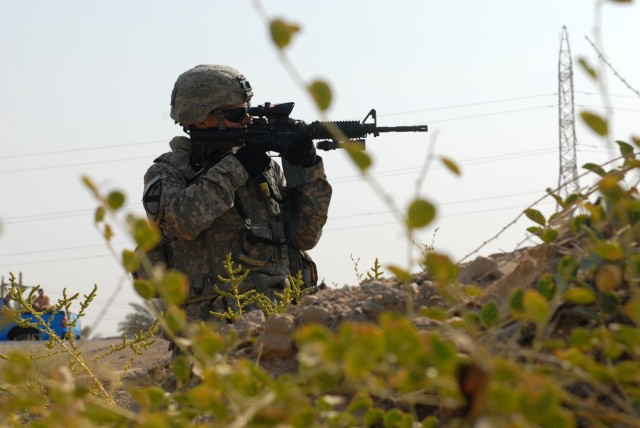TAJI, Iraq - Fort Myers, Fla. native, Spc. Matthew Medvecky, a medic from Headquarters and Headquarters Battery, 1st  Battalion, 82nd Field Artillery Regiment, 1st Brigade Combat Team, 1st Cavalry Division, scans his sector after hearing small...
