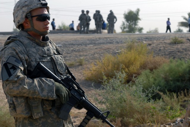 TAJI, Iraq - Sgt. Corey Edwards, a truck commander from Gravity, Iowa, assigned to Battery B, 1st Battalion, 82nd Field Artillery Regiment, 1st Brigade Combat Team, 1st Cavalry Division, provides security at an improvised explosive device blast...