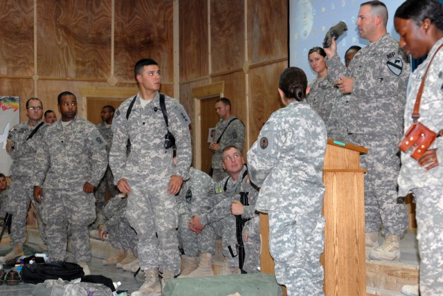 BAGHDAD - Sgt. 1st Class Travis Huggard (right), from Kodiak Island, Alaska, assigned to Company A, Division Special Troops Battalion, 1st Cavalry Div., explains bag inspection procedures during a customs class at Hope Chapel on Camp Victory, here, A...