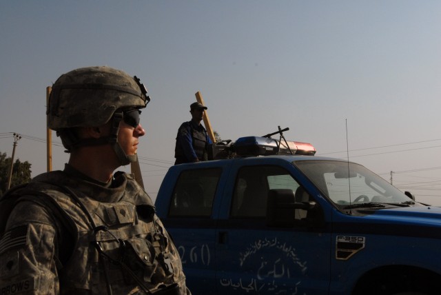 CAMP TAJI, Iraq- Pennsboro, W. Va. native Spc. Christopher Burrows, a forward observer assigned to Headquarters and Headquarters Battery, 1st Battalion, 82nd Field Artillery Regiment, 1st Brigade Combat Team, 1st Cavalry Division, scans a neighboring...