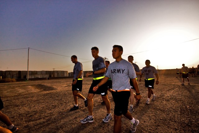 CAMP TAJI, Iraq-During a visit, Brig. Gen. Frederick Rudesheim (center), the deputy commanding general of support, 1st Cavalry Division, Multi-National Division - Baghdad, gets ready to run with the fastest Soldiers of Company F, 3rd Battalion, 1st A...