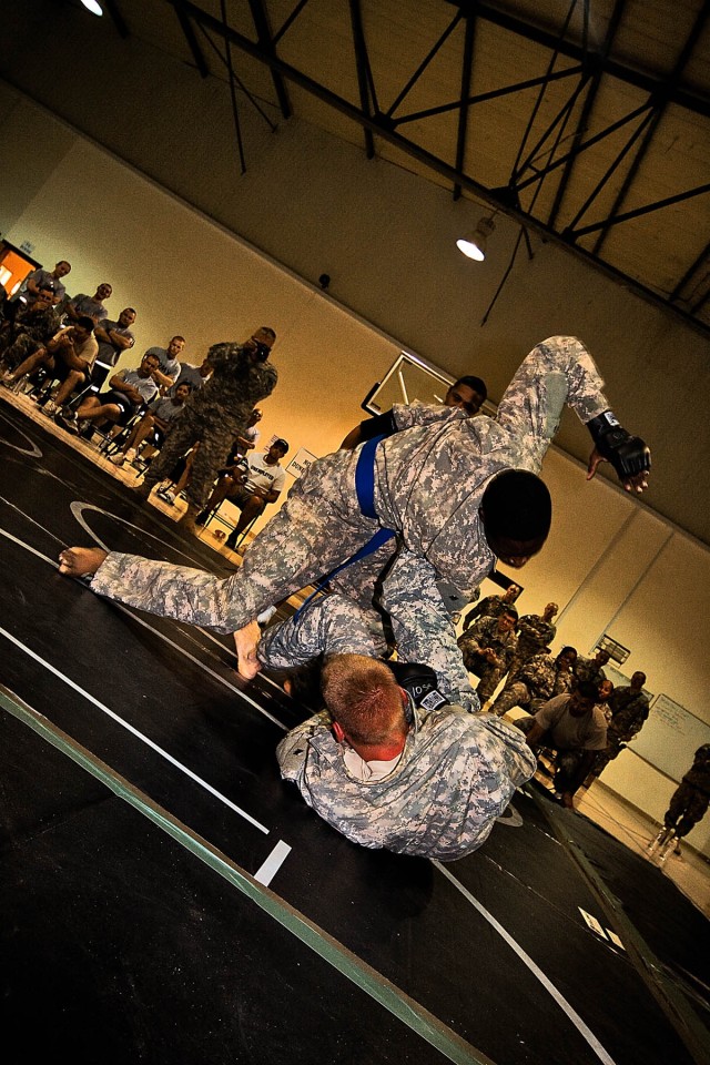 CAMP TAJI, Iraq-His oponent struggles for position as Spc. De Andre Jackson (blue belt), from San Francisco, a generator mechanic for Headquarters Support Company, 615th Aviation Support Battalion, 1st Air Cavalry Brigade, 1st Cavalry Division,...
