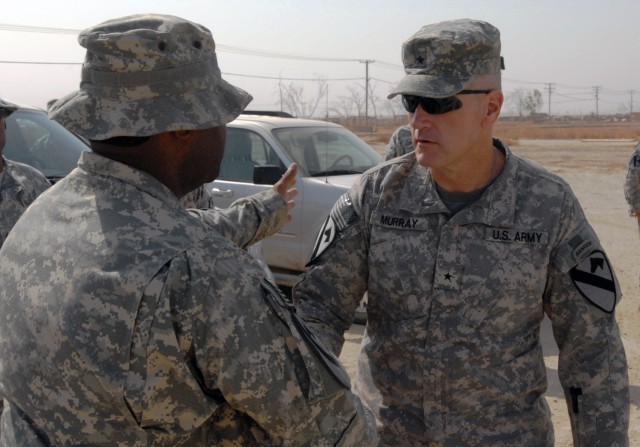CAMP TAJI, Iraq - Colquitt, Ga. Native, 1st. Sgt. Jamie Crankfield (left), the senior non commissioned officer assigned to Battery B, 1st "Dragons" Battalion, 82nd Field Artillery Regiment, 1st Brigade Combat Team, 1st Cavalry Division, welcomes Kent...