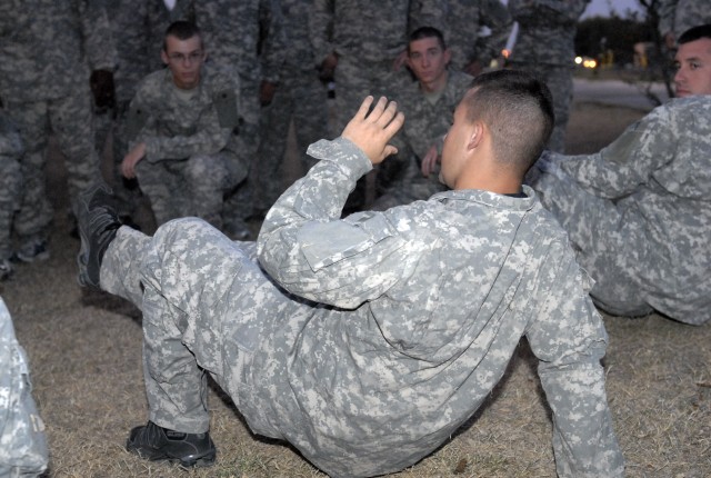 Pfc. Brent Moore, assigned to the 4th Special Troops Battalion, 1st Cavalry Division, teaches his company a combatives technique during one of their weekly classes on Fort Hood Sept. 1.  Moore is level two certified and is the lead instructor for his...