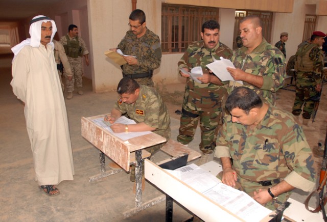 Members of the Iraqi Security Forces examine a villager's paperwork during operation "Enforce the Law VI" in the Rashaad Valley in Kirkuk province, Iraq, Sept. 2. The village was allowed to go back to his home freely after the ISF confirmed his...