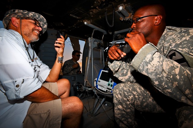 CAMP TAJI, Iraq-While sitting in a UH-60 Black Hawk medevac helicopter, Sgt. 1st Class Cleron (right) Washington, from Walter Berg, S.C., the flight medic noncommissioned officer in charge for Company C, 2nd Battalion, 227th Aviation Regiment, 1st Ai...
