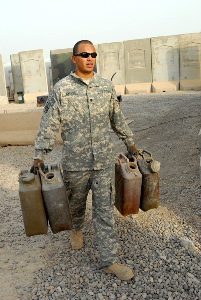 BAGHDAD - Spc. Thomas Lyons, a fuel supply specialist from Akron, Ohio, retrieves empty five-gallon containers to fill at a fuel point at Victory Base Complex, here, Sept. 8.  Lyons, along with other fuel handlers from Headquarters Support Company, D...