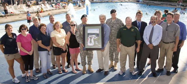 PICATINNY ARSENAL, N.J. - Lt. Col. John P. Stack, Picatinny's Garrison Commander (center in uniform) presents Mayor Louis S. Sceusi of Rockaway Township with a framed photo of the Picatinny Frog Falls Aquatic Park during its 10-year anniversary celeb...