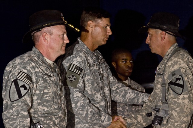 CAMP TAJI, Iraq-During an awards ceremony held Sept. 12, at Camp Taji, Iraq, Brig. Gen. Frederick Rudesheim (center), the deputy commanding general of support, 1st Cavalry Division, Multi-National Division - Baghdad, and Col. Douglas Gabram (left), f...