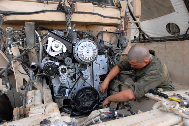 CAMP LIBERTY, Iraq - All-wheel mechanic, Spc. Catlynn Kovacs, from Colorado Springs, Colo., assigned to Headquarters Support Company, Division Special Troops Battalion, 1st Cavalry Division, checks each part of a new engine on a Mine-Resistant...