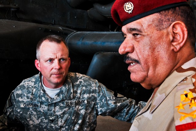 CAMP TAJI, Iraq-Col. Douglas Gabram (left), from Cleveland, Ohio, commander of the 1st Air Cavalry Brigade, 1st Cavalry Division, Multi-National Division - Baghdad, meets with Gen. Abud Qanbar Hashim al-Maliki (right), commanding general, Baghdad...