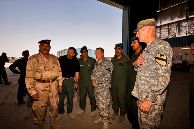 CAMP TAJI, Iraq-Showing sincere appreciation, Maj. Gen. Daniel Bolger (right), commanding general of the 1st Cavalry Division and Multi-National Division - Baghdad, thanks Gen. Abud Qanbar Hashim al-Maliki (left), commanding general, Baghdad...