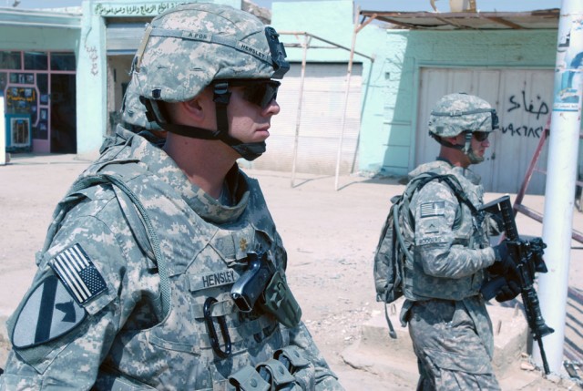 TAJI, Iraq- Fairfax, Va., native Maj. Robert Hensley (left), the battalion executive officer of 1st Battalion, 82nd Field Artillery Regiment, 1st Brigade Combat Team, 1st Cavalry Division, walks through the Taji market, Sept. 10,  as the "Dragons"...