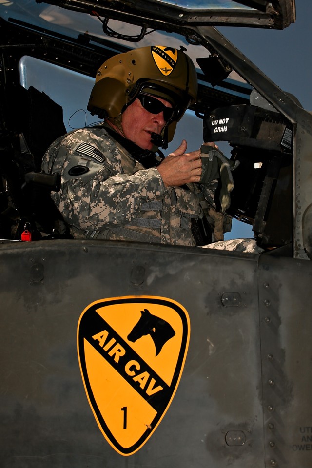 CAMP TAJI, Iraq-Maj. Gen. James Hunt, deputy commanding general, Multi-National Corps - Iraq, prepares for his first flight in an AH-64D Apache attack helicopter during his visit to 1st Battalion, 227th Aviation Regiment, 1st Air Cavalry Brigade, 1st...