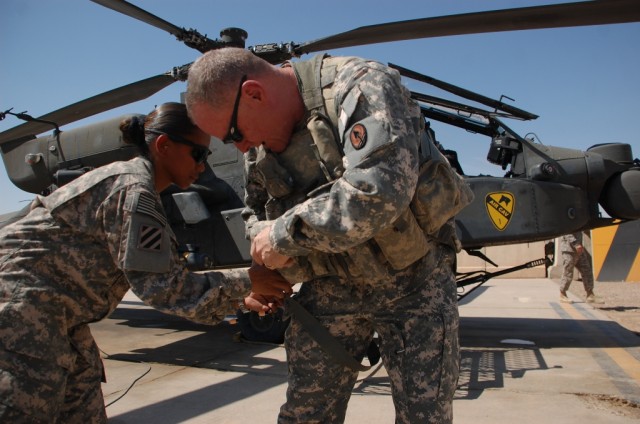 CAMP TAJI, Iraq-Sgt. Marilyn C. Ortega (left), from Houston, the aviation life support equipment noncommissioned officer in charge for 1st Battalion, 227th Aviation Regiment, 1st Air Cavalry Brigade, 1st Cavalry Division, Multi-National Division -...