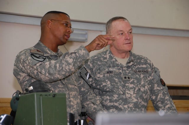 CAMP TAJI, Iraq-Lt. Col. Charles Dalcourt (left), from Baton Rouge, La., commander, 1st Battalion, 227th Aviation Regiment, 1st Air Cavalry Brigade, 1st Cavalry Division, Multi-National Division - Baghdad, shares with Maj. Gen. James Hunt (right), de...
