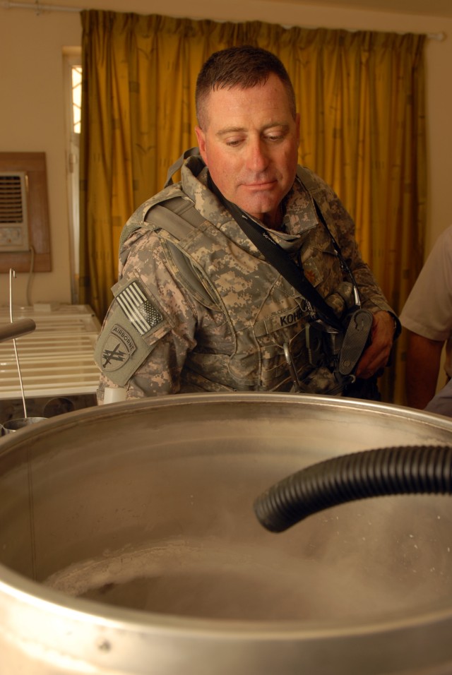 BAGHDAD - Maj. Marshall Kohr, a civil affairs officer assigned to the 414th Civil Affairs Battalion, based in Southfield, Mich., peers into a freezer used for storing bovine semen at the University of Baghdad's College of Agriculture, Sept. 13....