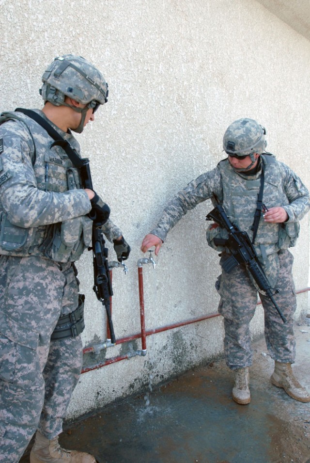 TAJI, Iraq- Cambridge, Mass., native Staff Sgt. Carlos Madden (left), a civil affairs team leader assigned to 1479 Civil Affairs Company, attached to 1st Battalion, 82nd Field Artillery Regiment, 1st Brigade Combat Team,1st Cavalry Division, and...