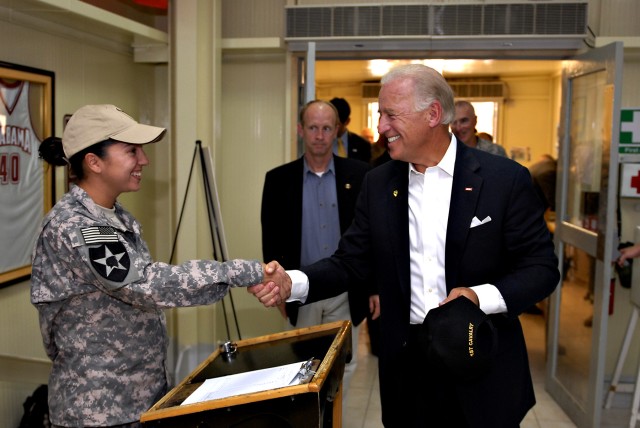 Spc. Tonya Nichols, a shift leader at the Pegasus Dining Facility on Camp Liberty, Iraq, with Headquarters Support Company, Division Special Troops Battalion, Multi National Division-Baghdad, greets Vice President Joe Biden as he makes a surprise vis...