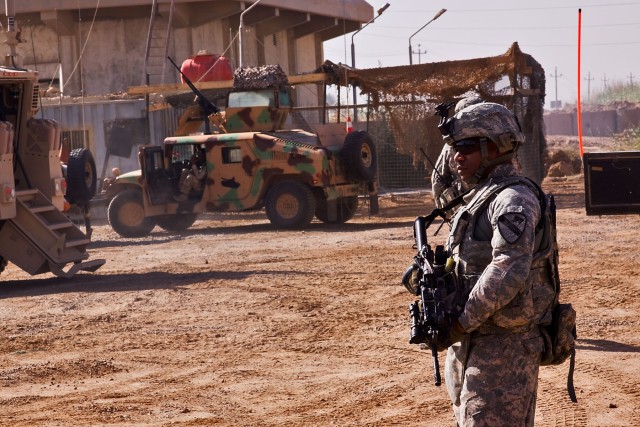 TAJI, Iraq-1st Sgt. Derrick Allard, from Charleston, S.C., Company F, 3rd Battalion, 227th Aviation Regiment, 1st Air Cavalry Brigade, 1st Cavalry Division, Mutli-National Division - Baghdad, observes his Soldiers who are part of a personal...