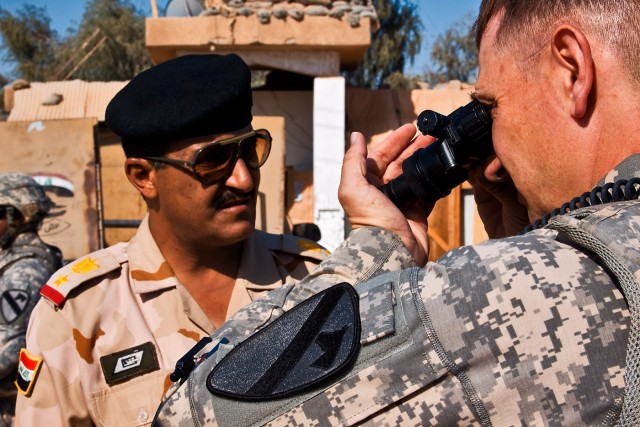 TAJI, Iraq-During an inspection of a water treatment facility guarded by the 34th Iraqi Army Brigade, Lt. Col. William Bohman (right), from Cincinnati, the officer in charge of a military transition team assigned to the 34th IA Bde., checks...