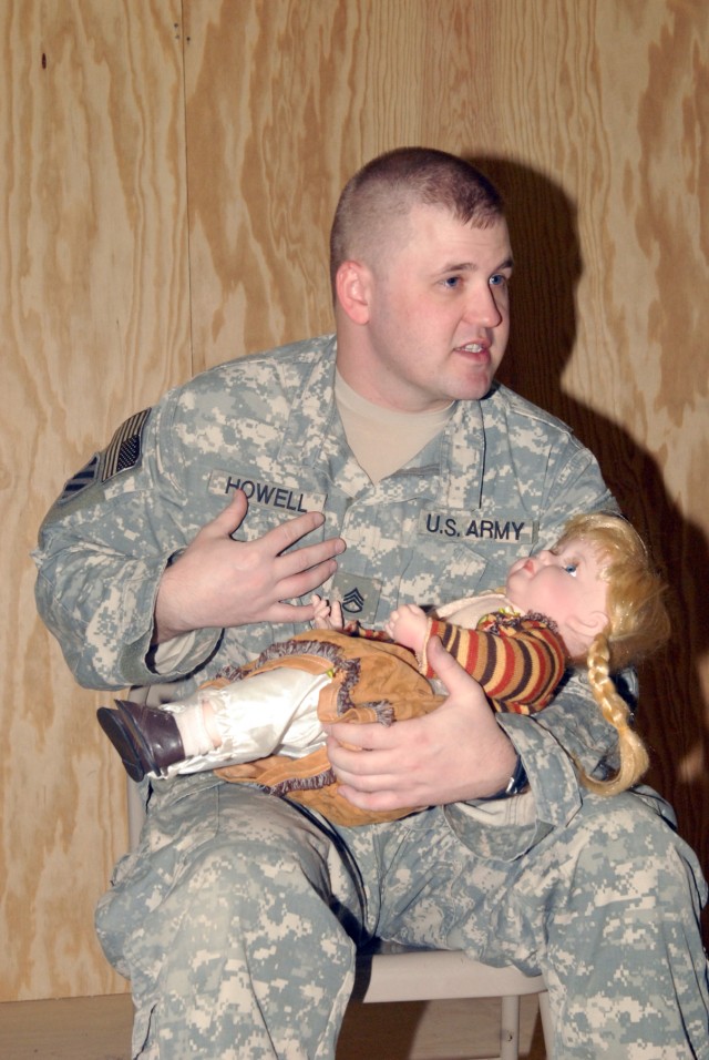BAGHDAD - Staff Sgt. Chris Howell, a medic assigned to Company A, 2nd Battalion, 5th Cavalry Regiment, 1st Brigade Combat Team, 1st Cavalry Division, uses a baby doll to show Iraqi emergency medical technicians the proper way to check airways in a...