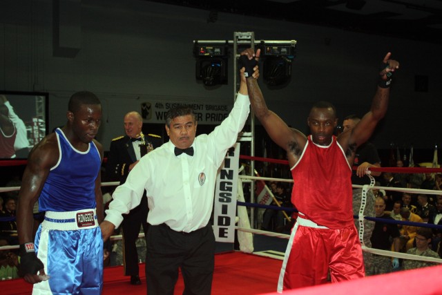 Sgt. Reshard Hicks, 27th Brigade Support Battalion, 4th Brigade Combat Team, 1st Cavalry Division, raises his hands in triumph over Pvt. Josh Franklin of the 3rd Armored Cavalry Regiment. Hicks won the III Corps and Fort Hood boxing championship...