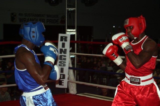 Sgt. Reshard Hicks, 27th Brigade Support Battalion, 4th Brigade Combat Team, 1st Cavalry Division, prepares to punch Pvt. Josh Franklin of the 3rd Armored Cavalry Regiment. Hicks won the Fort Hood and III Corps boxing championship for the 154 -165 we...