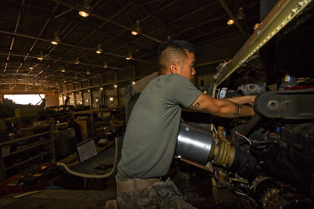 CAMP TAJI, Iraq-Spc. Son Le, from Tomball, Texas, an AH-64D Apache attack helicopter mechanic in Company B, 615th Aviation Support Battalion, 1st Air Cavalry Brigade, 1st Cavalry Division, Multi-National Division - Baghdad, secures the mounts of...