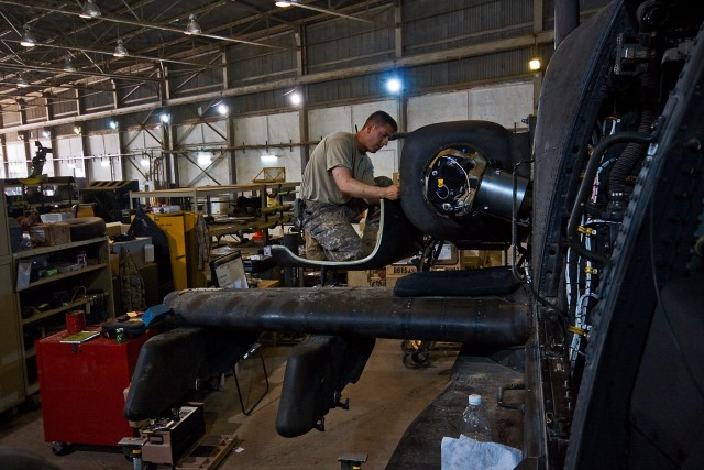 CAMP TAJI, Iraq-During a 500 hour phase maintenance inspection on an AH-64D Apache attack helicopter, Spc David Reed, from Spokane, Wash., an Apache mechanic in Company B, 615th Aviation Support Battalion, 1st Air Cavalry Brigade, 1st Cavalry...