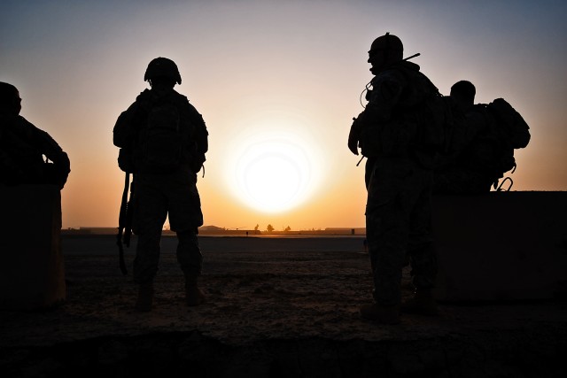 TAJI, Iraq-The sun rises as Soldiers of Company F, 3rd Battalion, 227th Aviation Regiment, 1st Air Cavalry Brigade, 1st Cavalry Division, Multi-National Division - Baghdad, wait in the early morning for two UH-60 Black Hawk helicopters to pick...