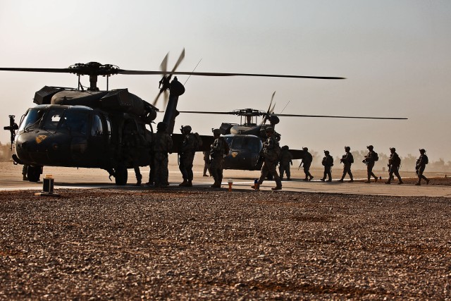 TAJI, Iraq-Loading on Black Hawk helicopters, Soldiers of Company F, 3rd Battalion, 227th Aviation Regiment, 1st Cavalry Brigade, 1st Cavalry Division, Multi-National Division - Baghdad, prepare to fly to a nearby town and conduct a presence...