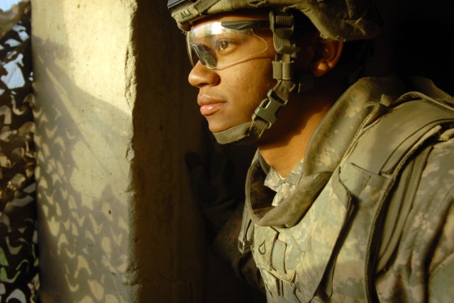BAGHDAD - Pfc. Ahmed Ali, of Brooklyn, New York, watches from a guard tower at Joint Security Station Ur, here, Sept. 20. Ali, a combat engineer assigned to Company E, 2nd Battalion, 5th Cavalry Regiment, 1st Brigade Combat Team, 1st Cavalry...