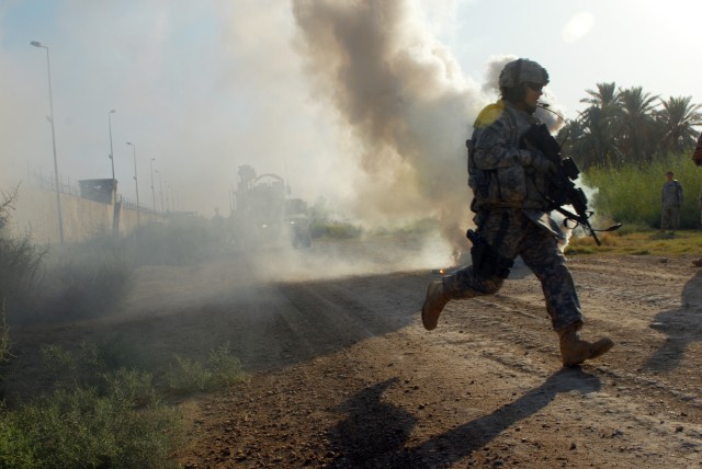 BAGHDAD - After popping a smoke grenade to signal where medevac helicopters should land, Sgt. James Wendling, a team leader from Mansfield, Ohio, assigned to D Troop, Division Special Troops Battalion, 1st Cavalry Division, runs to re-assure a simula...